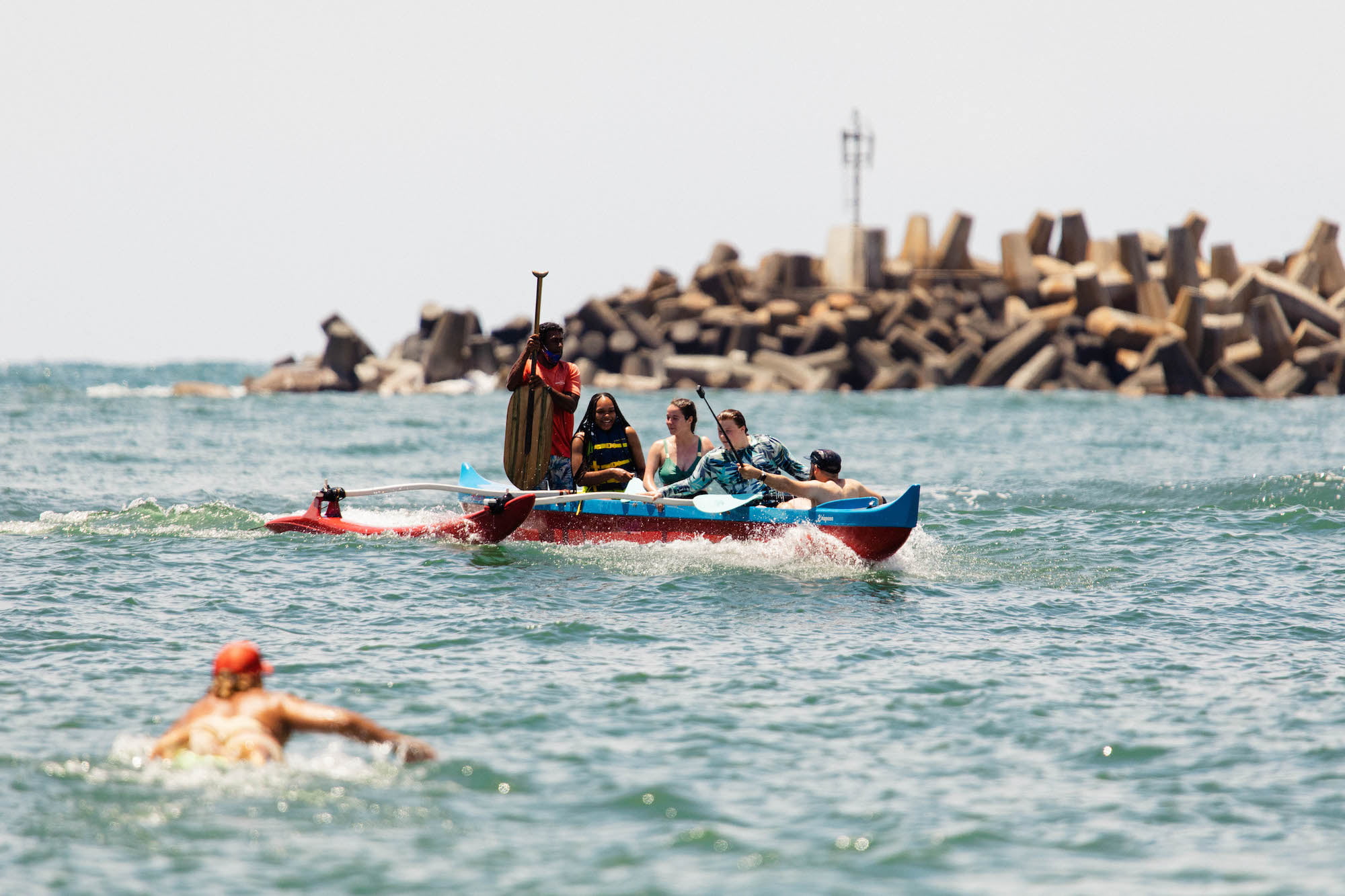 Retreat attendees outrigger canoe surfing
