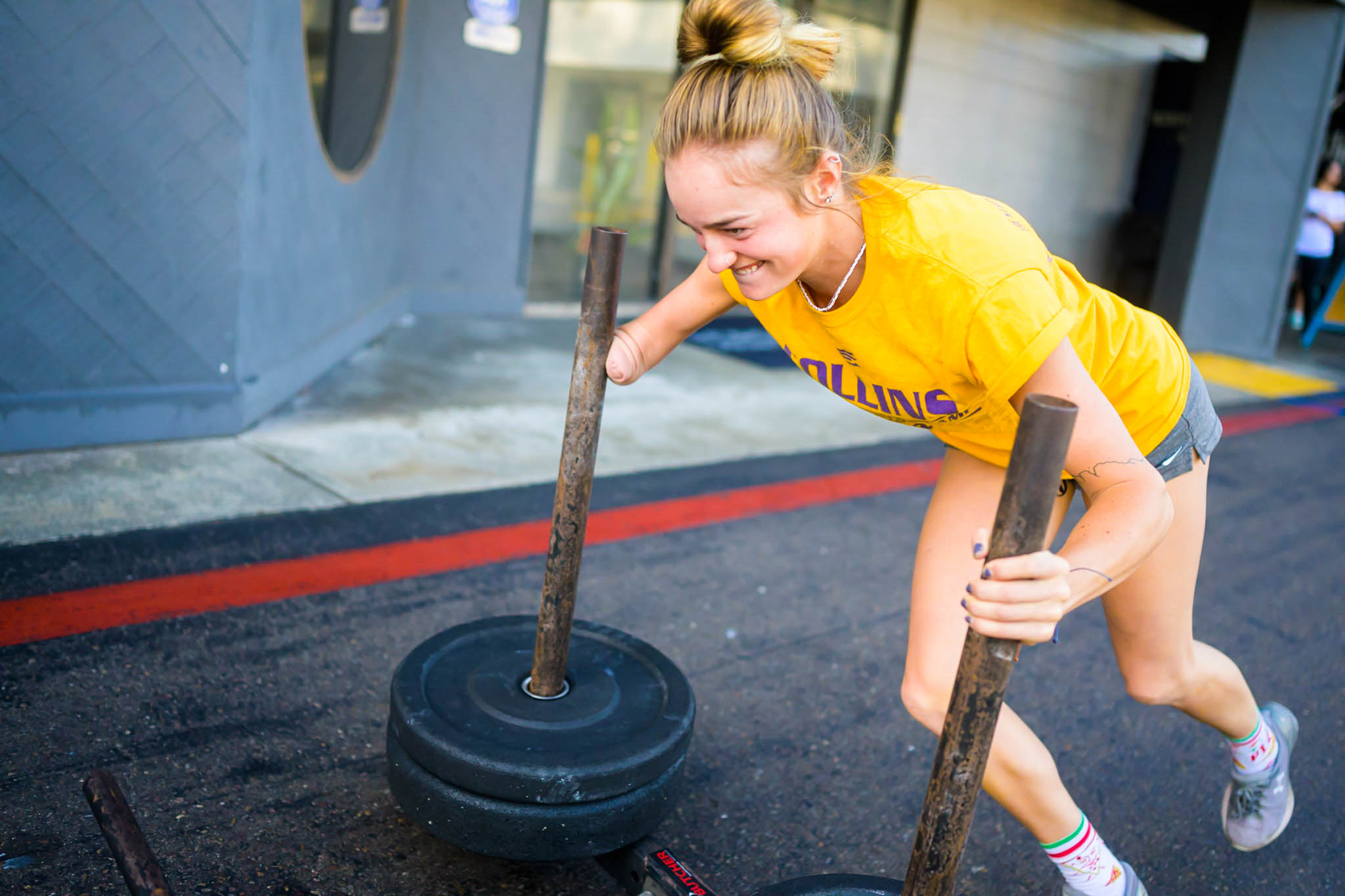 Beautifully Flawed attendee pushing a sled with weight on it