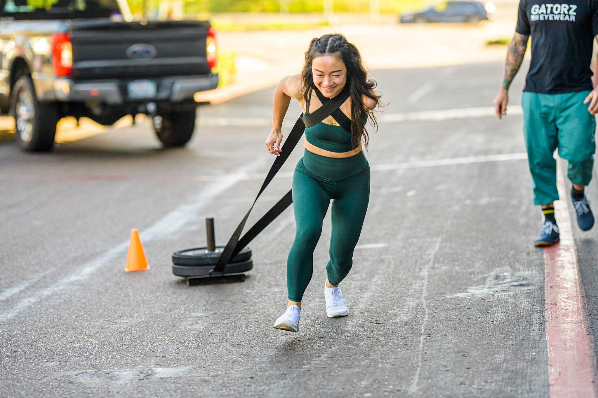 Beautifully Flawed attendee pulling a sled with weight on it