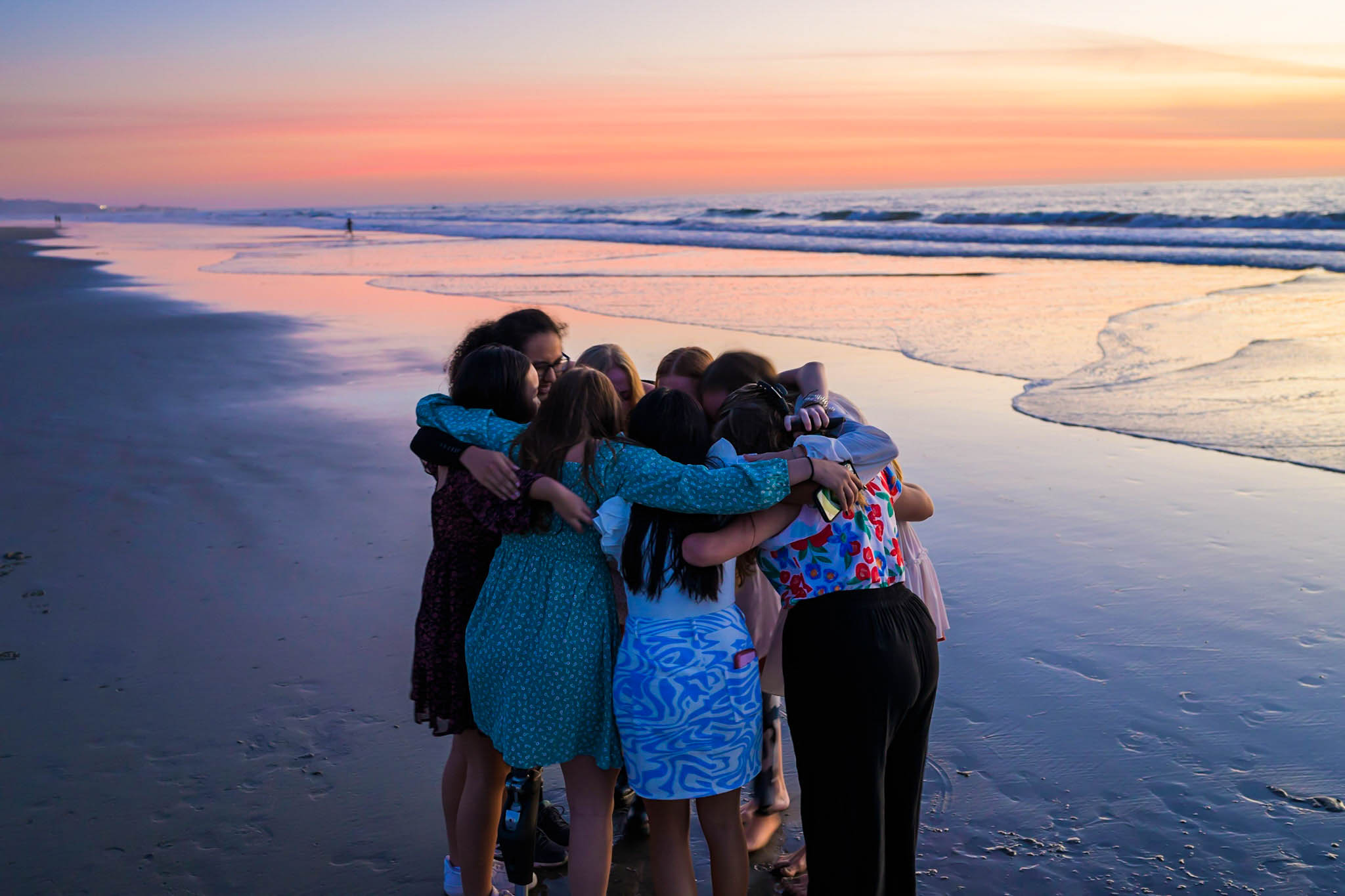 Beautifully Flawed attendees in a group hug