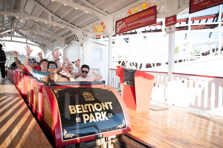 The Forge men cheer riding on the roller coaster at Belmont Park in San Diego, California.