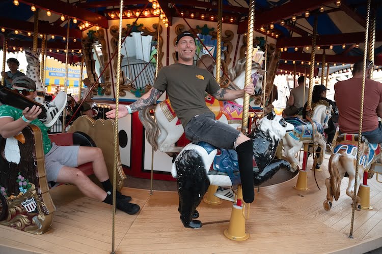 Forge attendee Ira has fun riding the carousel ride at Belmont Park.