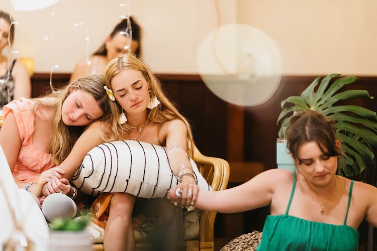 Three Beautifully Flawed attendees hold hands during prayer even with their arm limb differencees.