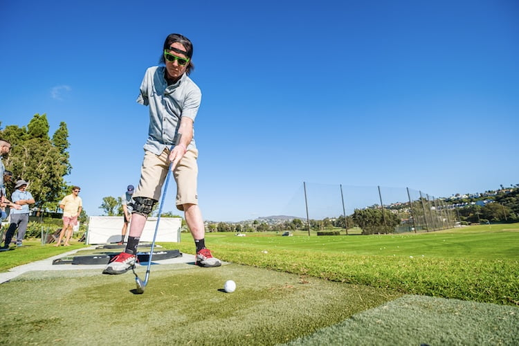 Forge attendee Shane gets ready to swing his golf club at the driving range despite only have one arm.