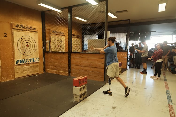 Forge attendee throws an axe at the target.