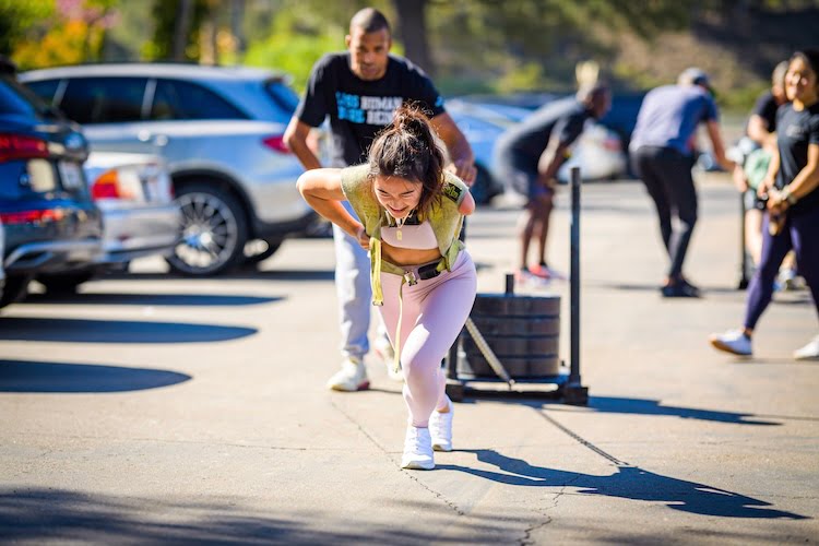 Beautifully Flawed attendee Natalee uses all her might to pull a weighted sled in this classic CrossFit workout despite missing her left arm.