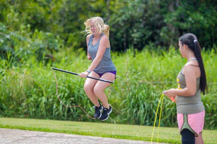 Beautifully Flawed attendee Ava jumps rope using the RX Smart Gear adaptive jump rope despite missing her right arm.