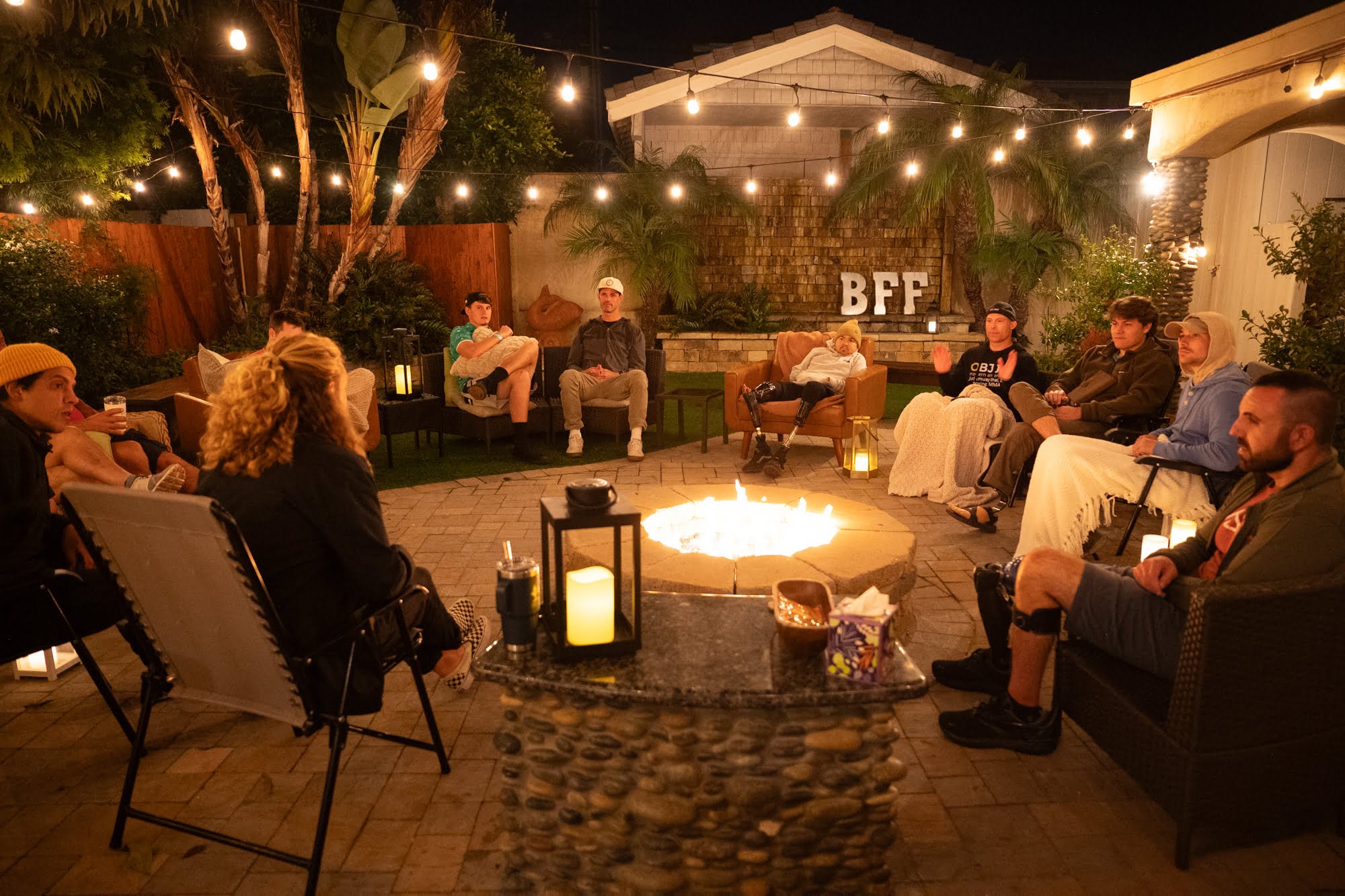 Forge attendees and leaders in a group session around a fire