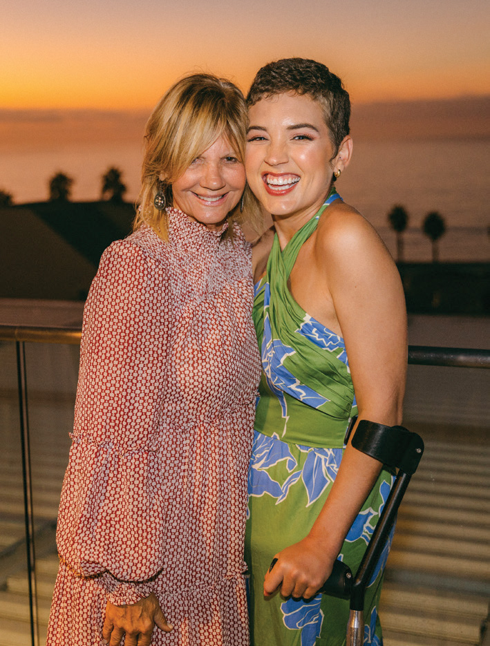 Lisa Curlee, Board Member and amputee, hugs first-time attendee Courtney at the retreat banquet dinner.